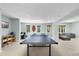 Spacious game room features a ping pong table, drum set, and comfortable seating area at 112 Roseberry Way, Holly Springs, NC 27540