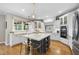 Modern kitchen featuring an island with bar seating, stainless steel appliances, and custom cabinetry at 112 Roseberry Way, Holly Springs, NC 27540
