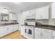 Updated kitchen featuring all-white cabinets and appliances at 112 Roseberry Way, Holly Springs, NC 27540