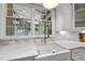 Farmhouse sink with white marble countertops and plenty of natural light, modern faucet, and tile backsplash at 112 Roseberry Way, Holly Springs, NC 27540