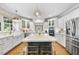 Bright, modern kitchen with a center island, stainless steel appliances, and ample counter space at 112 Roseberry Way, Holly Springs, NC 27540