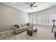 Living room featuring a couch, a TV, and a large window with natural light and a ceiling fan at 112 Roseberry Way, Holly Springs, NC 27540