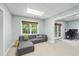 Cozy living room features a comfortable sectional couch and a view of the backyard at 112 Roseberry Way, Holly Springs, NC 27540