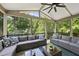 Spacious screened porch with comfortable seating and a view of the lush greenery at 112 Roseberry Way, Holly Springs, NC 27540