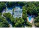 Aerial view of multiple tennis courts, swimming pool, and clubhouse surrounded by lush trees and greenery at 113 Wilander Dr, Cary, NC 27511