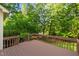 A well-maintained back deck overlooks a serene wooded backyard with mature trees and landscaping at 113 Wilander Dr, Cary, NC 27511