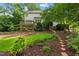 A beautifully landscaped backyard features a well-manicured lawn and a charming patio area at 113 Wilander Dr, Cary, NC 27511
