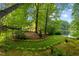 The peaceful backyard boasts mature trees and leads to a tranquil lakefront at 113 Wilander Dr, Cary, NC 27511