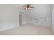 Carpeted bedroom with built-in shelving and drawers, closet, ceiling fan, and dormer ceiling at 113 Wilander Dr, Cary, NC 27511