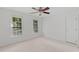 This bedroom is well-lit with neutral carpet, a ceiling fan, and two large windows at 113 Wilander Dr, Cary, NC 27511
