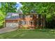 Charming two-story red brick home featuring a well-manicured front lawn and two-car garage at 113 Wilander Dr, Cary, NC 27511