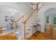 Bright foyer with hardwood floors and stairs, leading to a dining room with a chandelier at 113 Wilander Dr, Cary, NC 27511