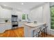 Bright, updated kitchen with white cabinets, stainless steel appliances, and a breakfast bar at 113 Wilander Dr, Cary, NC 27511