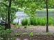 This home's backyard oasis has mature foliage and a tranquil lake view, perfect for relaxation at 113 Wilander Dr, Cary, NC 27511