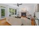 Bright living room with fireplace, neutral furniture, and large windows overlooking the backyard at 113 Wilander Dr, Cary, NC 27511