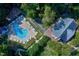 Aerial view of a community pool with lounge chairs surrounded by lush trees and greenery, adding a resort-like feel at 113 Wilander Dr, Cary, NC 27511