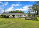 Spacious backyard featuring a wooden deck, carport, and mature trees, perfect for entertaining at 1169 Clayhole Rd, Dunn, NC 28334