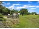 Large backyard featuring a wooden deck and mature trees, great for outdoor enjoyment at 1169 Clayhole Rd, Dunn, NC 28334