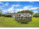 Spacious backyard featuring a wooden deck, carport, and mature trees, perfect for entertaining at 1169 Clayhole Rd, Dunn, NC 28334