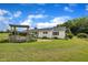 Spacious backyard with a wooden deck, lush lawn, and mature trees, offering privacy at 1169 Clayhole Rd, Dunn, NC 28334