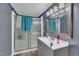 Well-lit bathroom features gray vanity, shower with glass door and gray walls at 1169 Clayhole Rd, Dunn, NC 28334