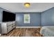 Comfortable bedroom featuring modern wood floors, ample natural light, and contemporary decor at 1169 Clayhole Rd, Dunn, NC 28334