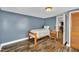 Cozy bedroom featuring modern wood floors, a twin bed, and a bright window for natural light at 1169 Clayhole Rd, Dunn, NC 28334