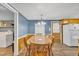 Bright dining area featuring a large table, seating for eight, and direct access to the laundry room at 1169 Clayhole Rd, Dunn, NC 28334