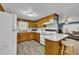 Charming kitchen features wood cabinets, breakfast bar with seating, and updated appliances at 1169 Clayhole Rd, Dunn, NC 28334