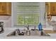 The kitchen sink features a stainless steel sink and a window with a view of the outdoors at 1169 Clayhole Rd, Dunn, NC 28334