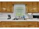 The kitchen sink features wood cabinets and a window with a view of the outdoors at 1169 Clayhole Rd, Dunn, NC 28334
