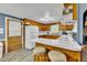 Charming kitchen features wood cabinets, breakfast bar with seating, and updated appliances at 1169 Clayhole Rd, Dunn, NC 28334
