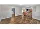 Open-concept living space with modern wood flooring, seamlessly connecting to the kitchen and laundry area at 1169 Clayhole Rd, Dunn, NC 28334