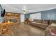 Inviting living room showcasing a cozy brick fireplace, wood-look floors and comfortable seating at 1169 Clayhole Rd, Dunn, NC 28334