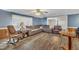 Comfortable living room with wood-look flooring, a plush couch and a rocking chair at 1169 Clayhole Rd, Dunn, NC 28334