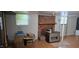 Spacious basement featuring wood-look flooring, a brick fireplace, and bright windows at 1223 Wallace St, Burlington, NC 27215