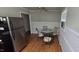Cozy dining room with wood floors, a glass table, and stainless steel refrigerator at 1223 Wallace St, Burlington, NC 27215