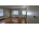 Bright living room featuring hardwood floors, large windows, and neutral walls at 1223 Wallace St, Burlington, NC 27215