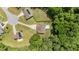This aerial view showcases a home with a backyard pool, garden, mature trees, and surrounding greenery at 123 Terawood Farm Dr, Willow Springs, NC 27592