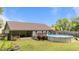 Sprawling backyard with a covered patio, lush green grass, and an above ground pool at 123 Terawood Farm Dr, Willow Springs, NC 27592