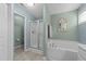 The spacious bathroom has dual sinks, a soaking tub, and a tiled walk-in shower at 123 Terawood Farm Dr, Willow Springs, NC 27592