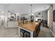 Open dining area with an adjacent kitchen, wood floors, and a decorative shelf, offering a cozy and inviting space at 123 Terawood Farm Dr, Willow Springs, NC 27592