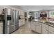 Modern kitchen featuring granite countertops, stainless steel appliances, and seamless flow to other living spaces at 123 Terawood Farm Dr, Willow Springs, NC 27592