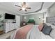 This main bedroom features decorative ceilings, a ceiling fan, and a tv above a dresser at 123 Terawood Farm Dr, Willow Springs, NC 27592