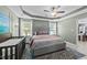 This main bedroom has decoratively framed ceilings, lots of natural light, and neutral colors at 123 Terawood Farm Dr, Willow Springs, NC 27592