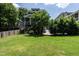 Expansive backyard with lush green lawn, mature trees, and a charming home exterior in a serene setting at 1313 Dale St, Raleigh, NC 27605