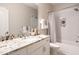 Bathroom featuring granite countertop, vanity, shower with tile surround, and decorative fixtures at 1313 Dale St, Raleigh, NC 27605