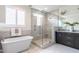 Luxurious bathroom with a freestanding tub, glass-enclosed shower, and double vanity, accented by modern fixtures at 1313 Dale St, Raleigh, NC 27605
