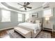 Serene bedroom with tray ceilings, soft lighting, and a plush bed, complemented by a stylish bench and neutral tones at 1313 Dale St, Raleigh, NC 27605
