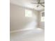 Bright bedroom with neutral walls, carpet, ceiling fan and light-filled windows at 1313 Dale St, Raleigh, NC 27605